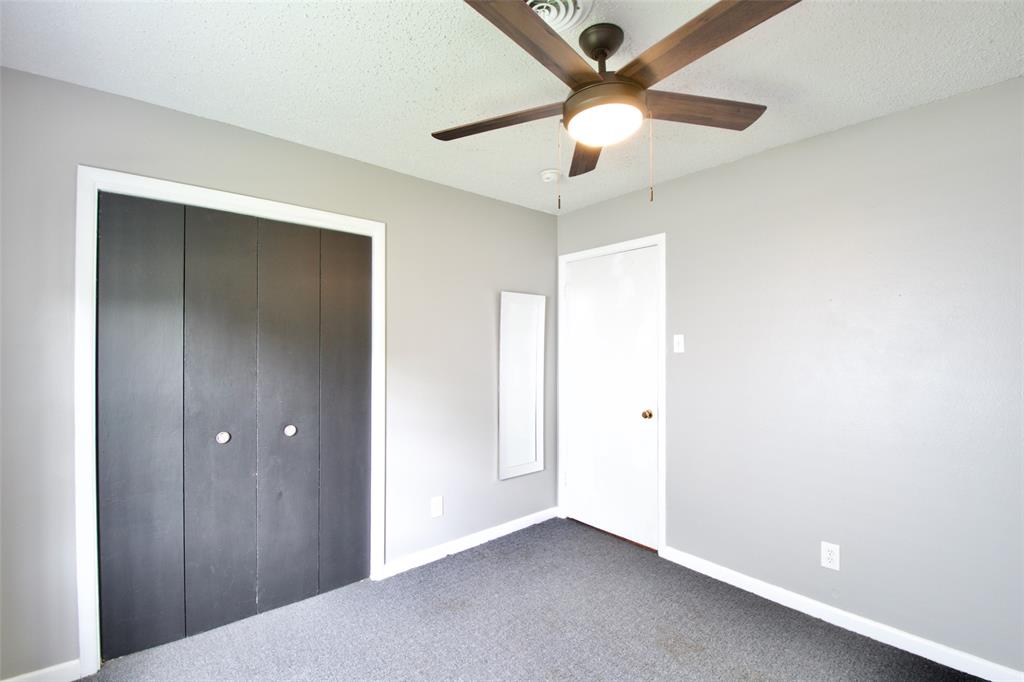 1307 North 65th Street Waco, TX 76710 - Photo 20 of 35 an empty room with closet and a chandelier fan