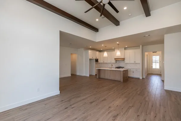 a view of kitchen with kitchen island wooden floor center island and appliances