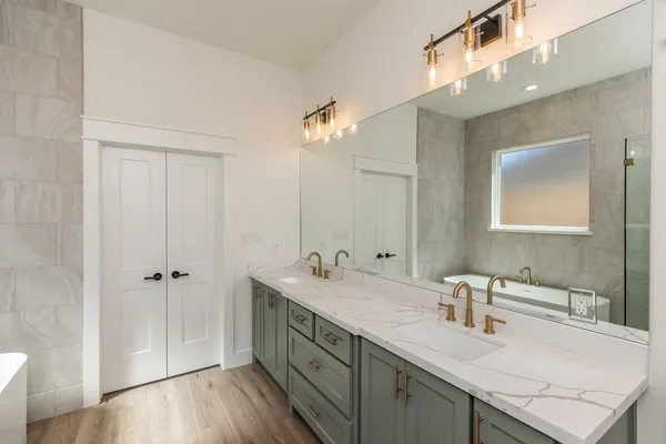 a bathroom with a sink a vanity and a mirror