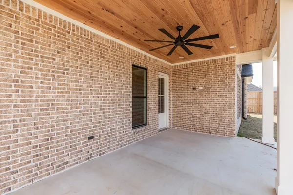 a view of a patio with a table and chairs
