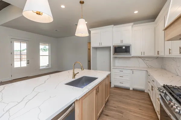 a kitchen with a sink stove and cabinets
