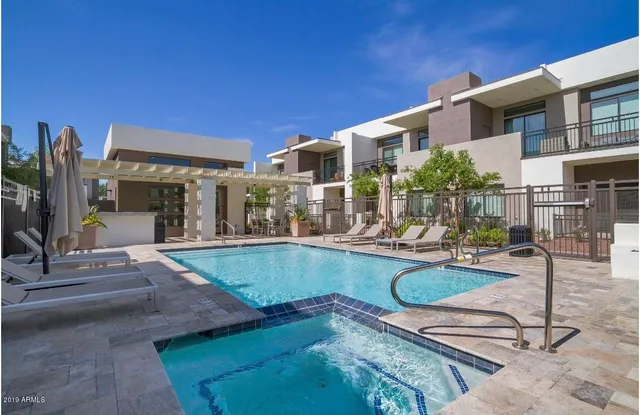 a swimming pool with outdoor seating and yard