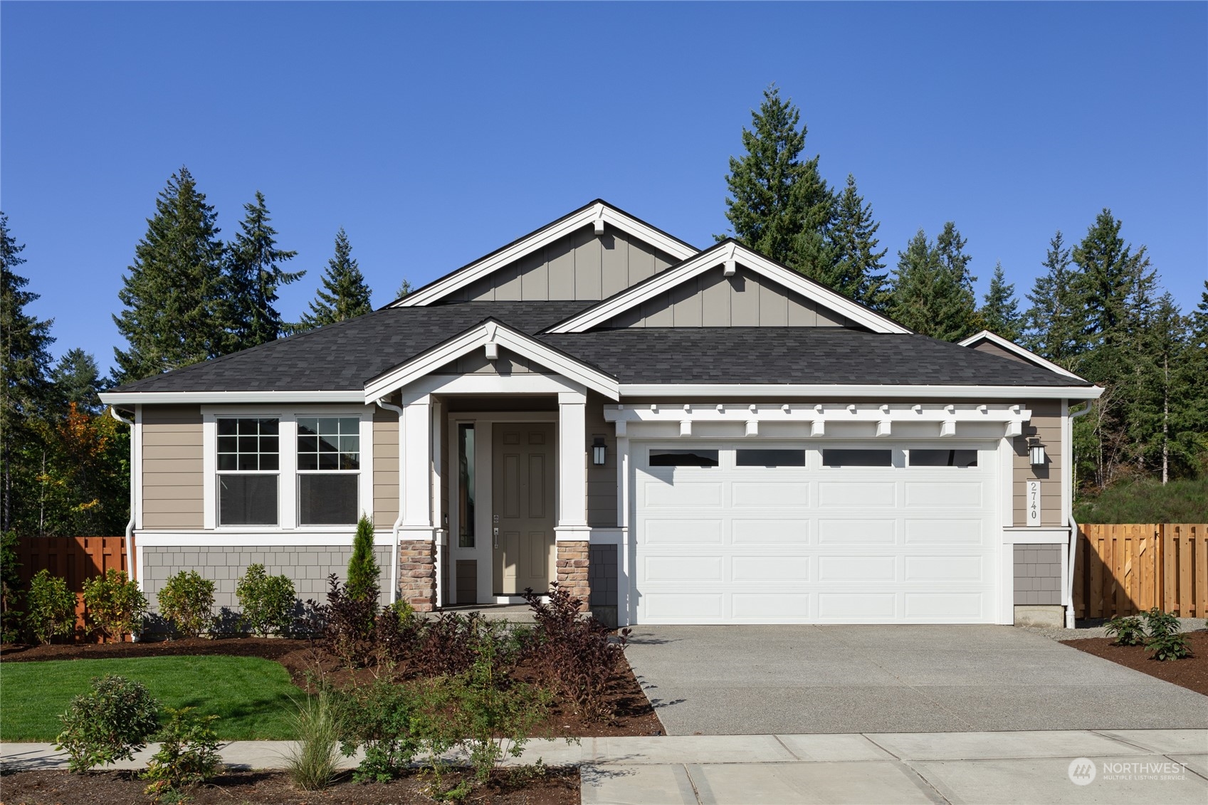 a front view of a house with a yard and trees