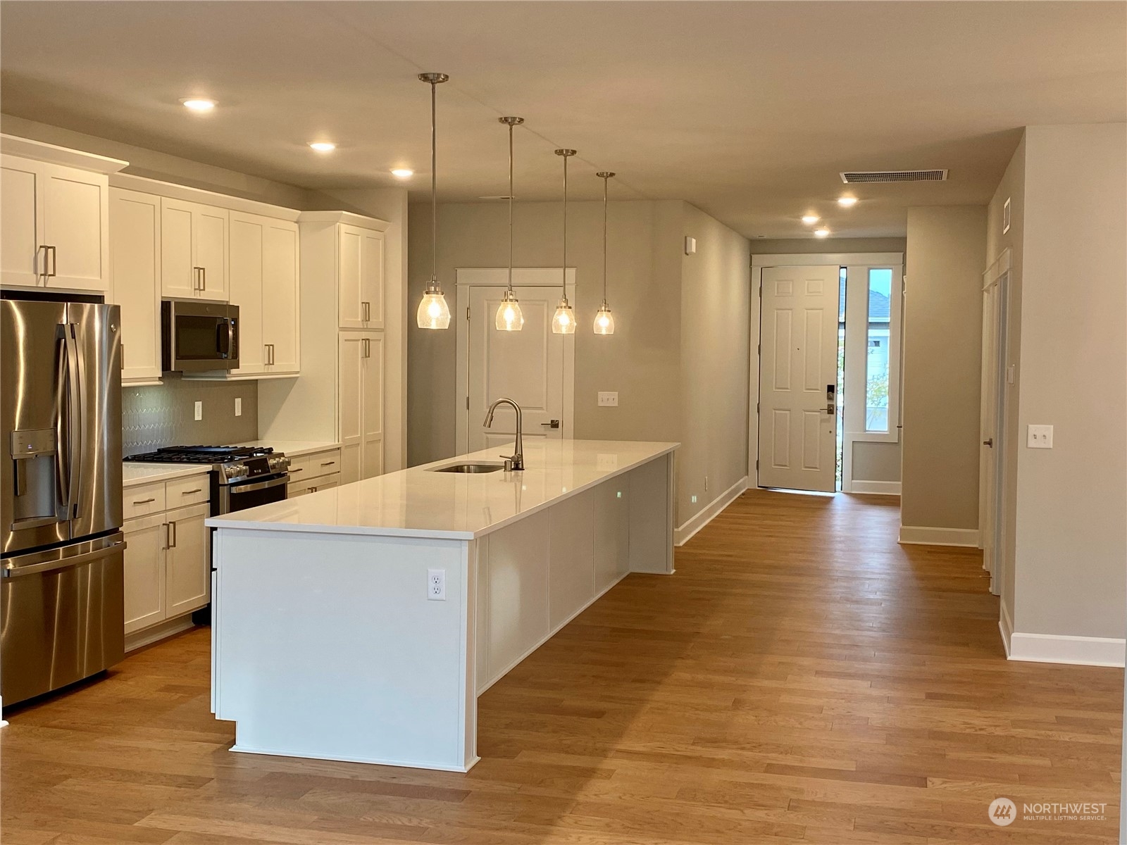 2740 Arrowroot Street Southeast Lacey, WA 98513 - Photo 2 of 15 a large kitchen with a large window and stainless steel appliances