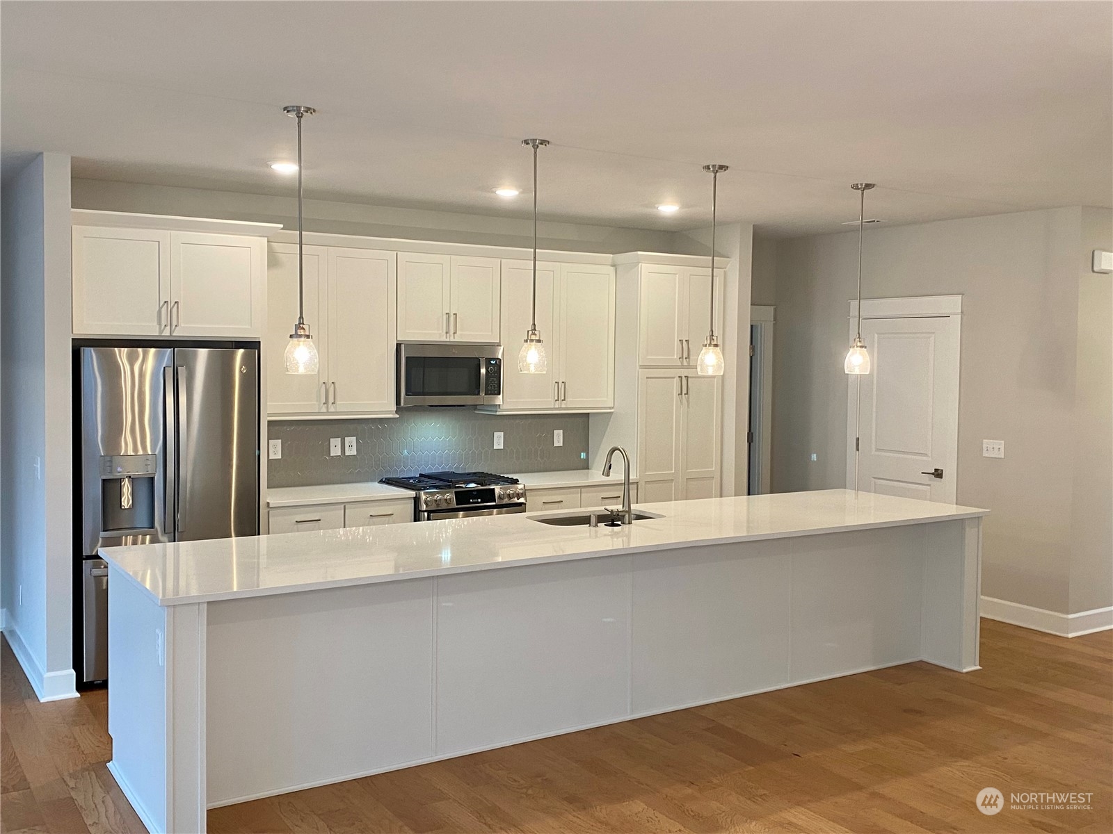 2740 Arrowroot Street Southeast Lacey, WA 98513 - Photo 3 of 15 a kitchen with stainless steel appliances a refrigerator sink and microwave