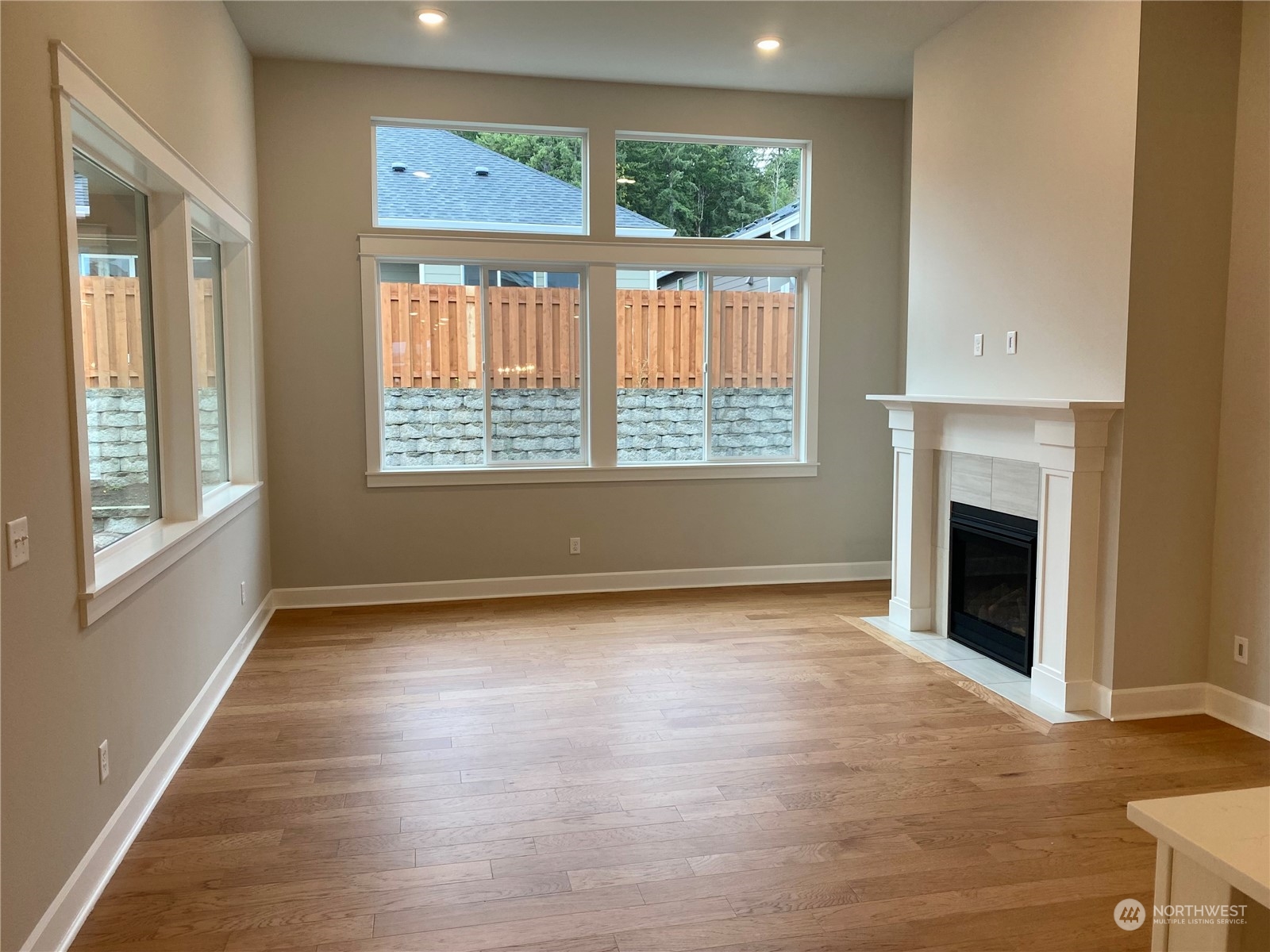 2740 Arrowroot Street Southeast Lacey, WA 98513 - Photo 4 of 15 a view of an empty room with a window and fireplace