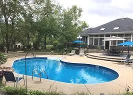 a view of a house with swimming pool and sitting area