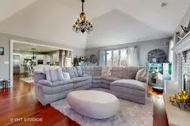 a living room with furniture and a chandelier