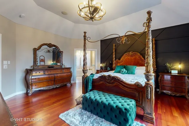 a bedroom with furniture and a wooden floor