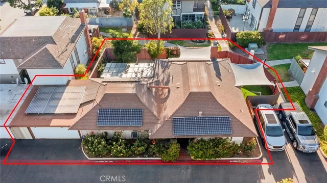 an aerial view of multiple houses with a yard