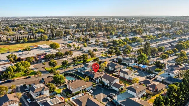 an aerial view of residential houses with city view