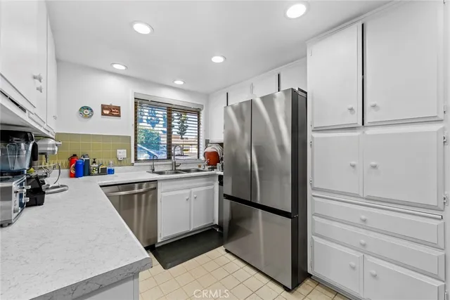 a kitchen with refrigerator and window