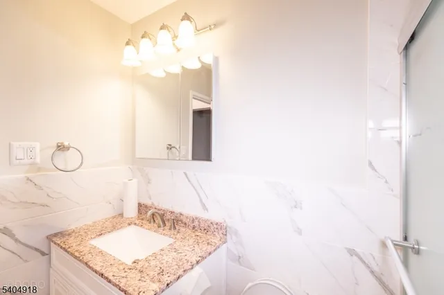 a bathroom with a sink vanity and a mirror