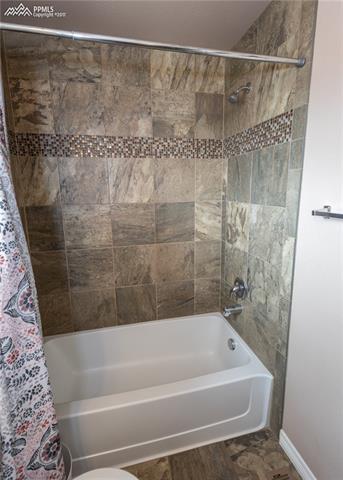 2105 Reed Grass Way Colorado Springs, CO 80915 - Photo 18 of 23 Custom tile flooring and shower surround in the second bathroom.