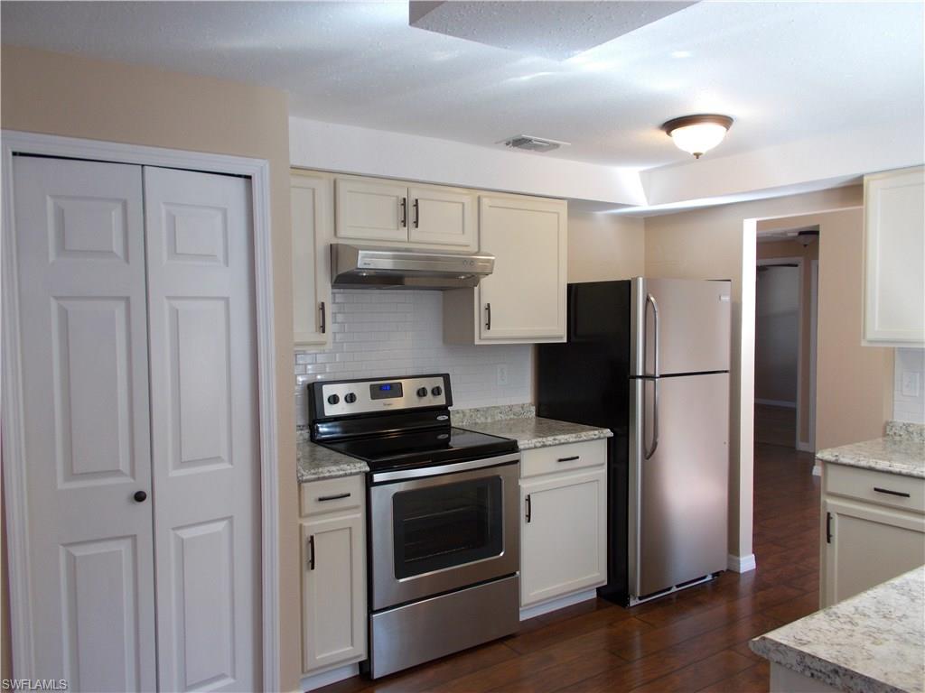 4180 Pine Ridge Road Naples, FL 34119 - Photo 14 of 25 VERY NICELY DONE KITCHEN AREA WITH GOOD SIZE PANTRY AND LIGHTING