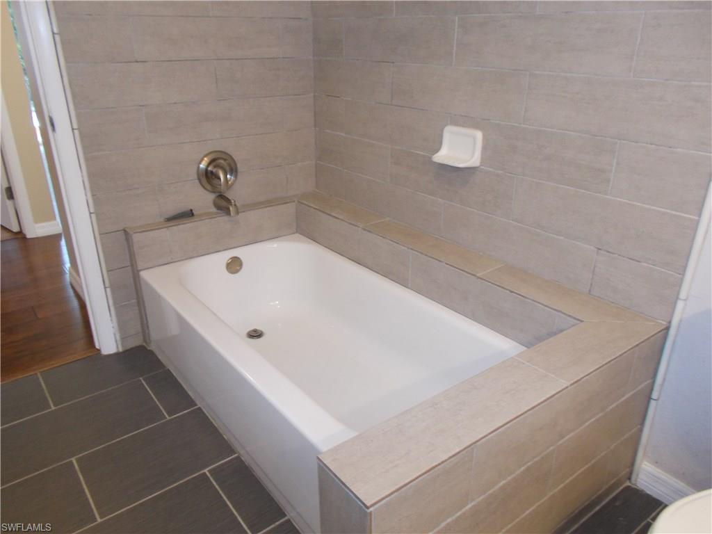 4180 Pine Ridge Road Naples, FL 34119 - Photo 8 of 25 NICELY TILED BATHROOM WITH LOTS OF SPACE