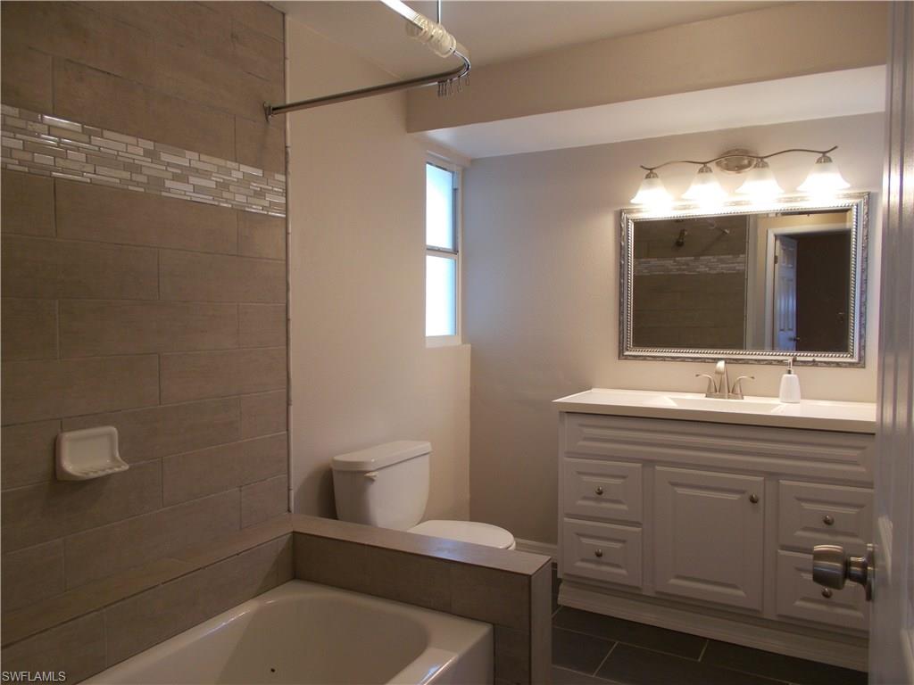 4180 Pine Ridge Road Naples, FL 34119 - Photo 9 of 25 SPACIOUS VANITY IN GUEST BATHROOM WITH PLENTY OF STORAGE