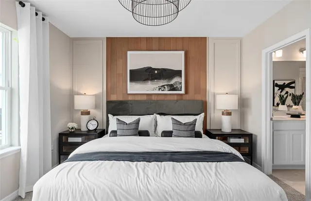 a bedroom with a bed and a painting on the wall