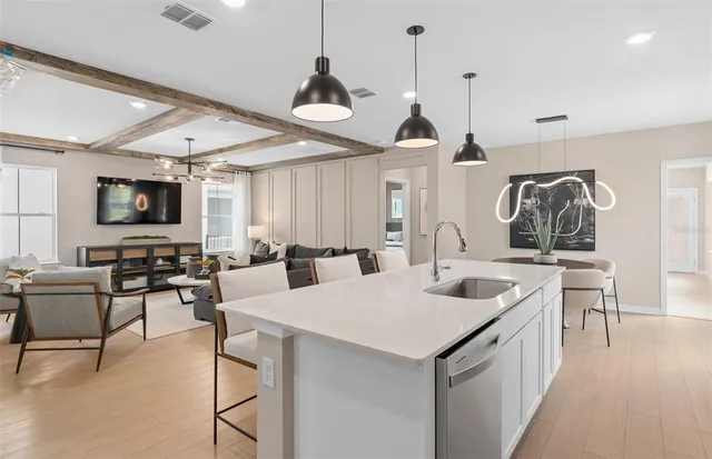 a living room with furniture a flat screen tv and a large window