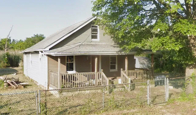 front view of a house with a chairs