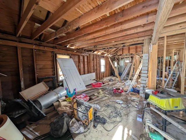 a bed room with a bed a couch and a table