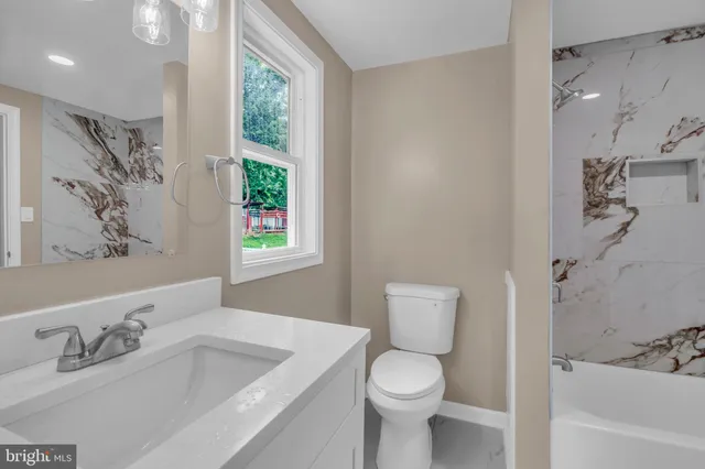 a bathroom with a sink a toilet and a bathtub