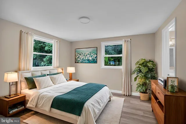 a bedroom with a bed table and a window