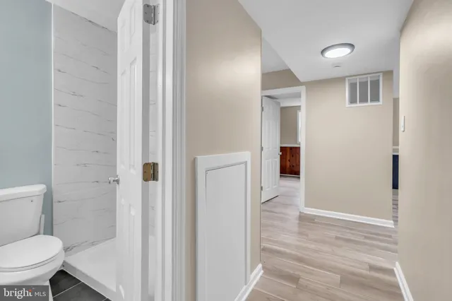 a bathroom with a toilet and a shower