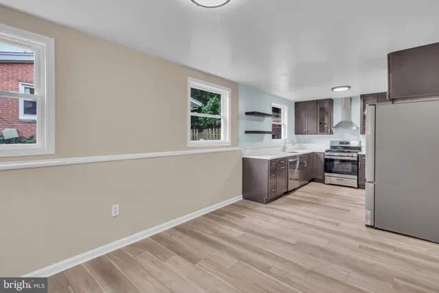 a kitchen with stainless steel appliances a refrigerator and a stove top oven