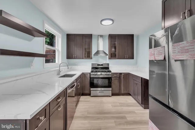 a kitchen with granite countertop a stove and a sink