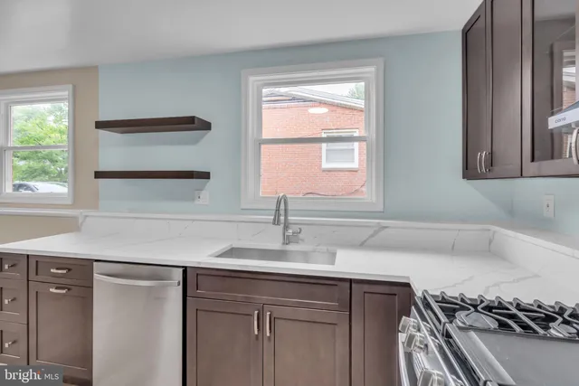 a kitchen with a sink cabinets and a window