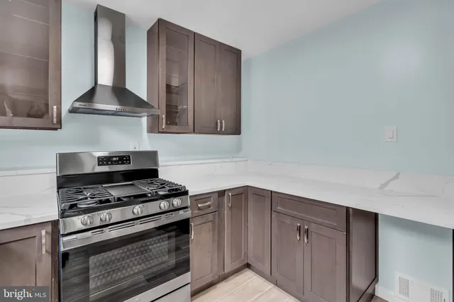a kitchen with stainless steel appliances a stove and cabinets