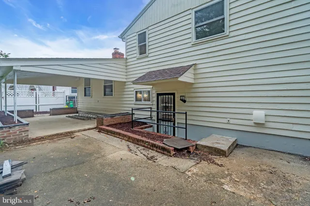 a view of a house with a small yard and wooden fence