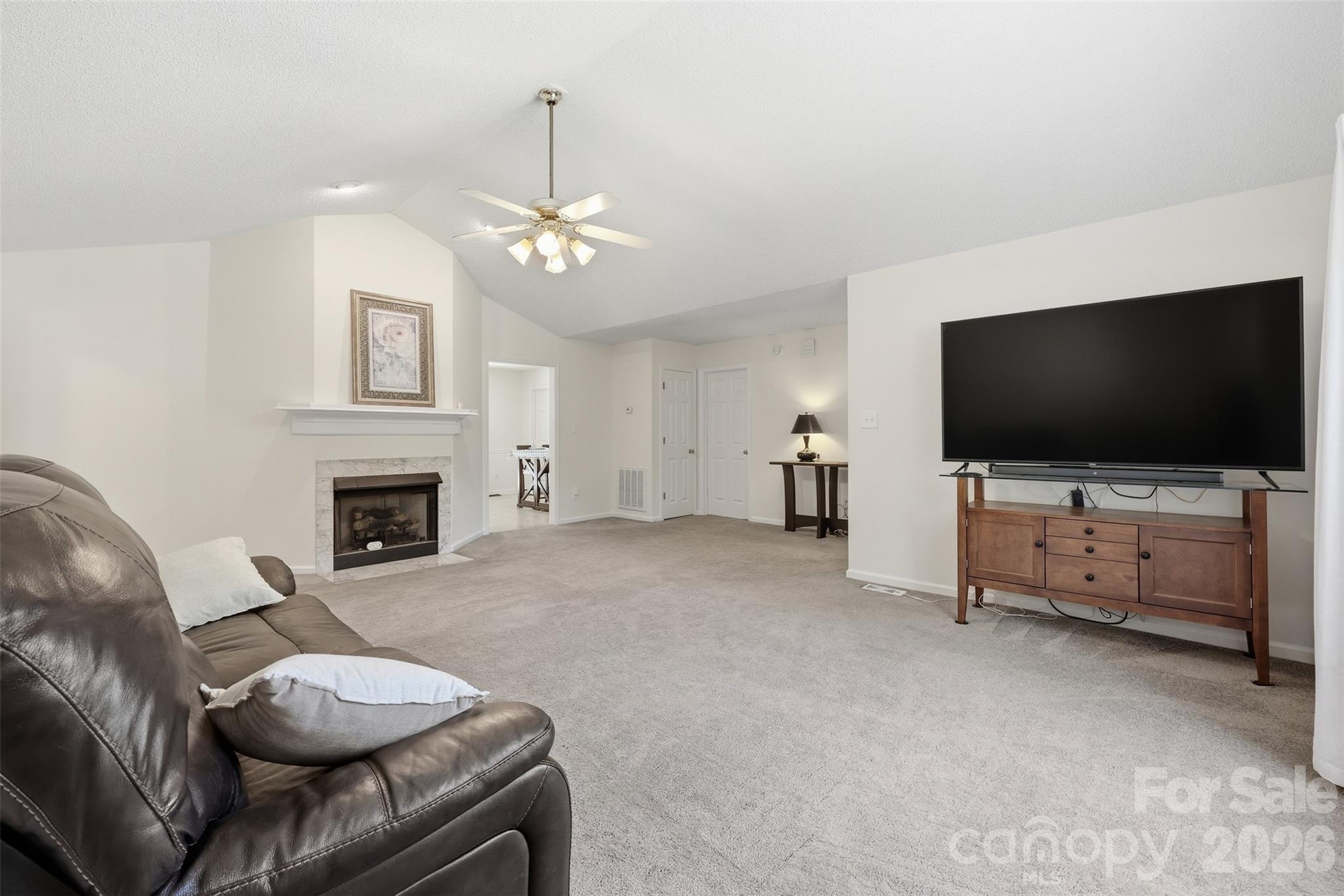 913 Pleasant Ridge Road Fort Mill, SC 29715 - Photo 6 of 40 a living room with furniture a flat screen tv and a fireplace