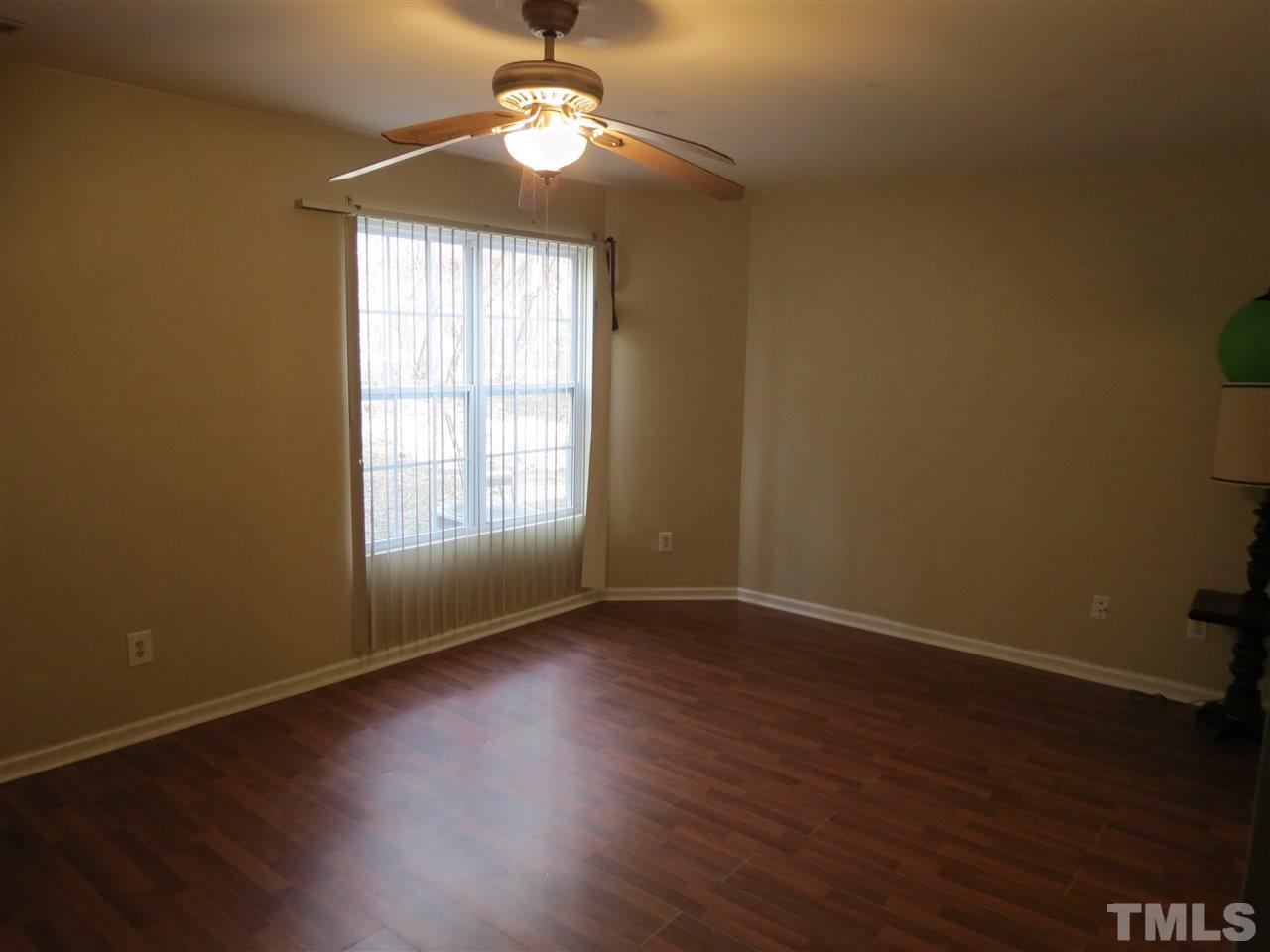 473 Dacian Road Raleigh, NC 27610 - Photo 4 of 10 a view of an empty room with wooden floor and a window