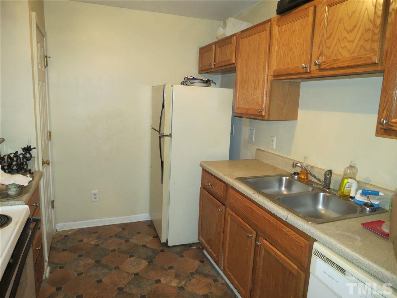 473 Dacian Road Raleigh, NC 27610 - Photo 5 of 10 a kitchen with a sink a refrigerator and cabinets