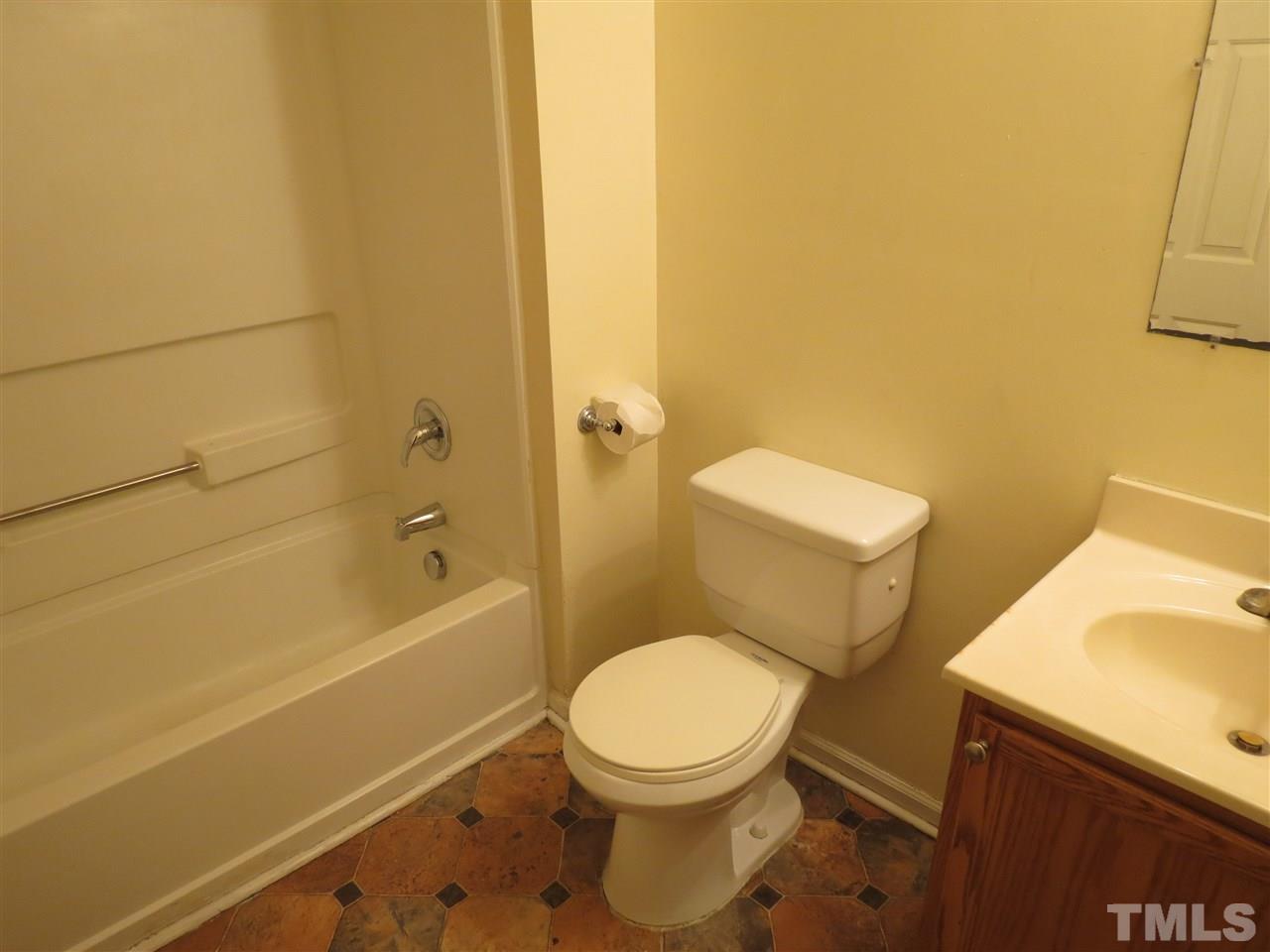 473 Dacian Road Raleigh, NC 27610 - Photo 10 of 10 a white toilet sitting next to a bath tub