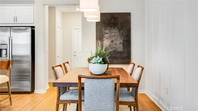 a dining room with furniture and wooden floor