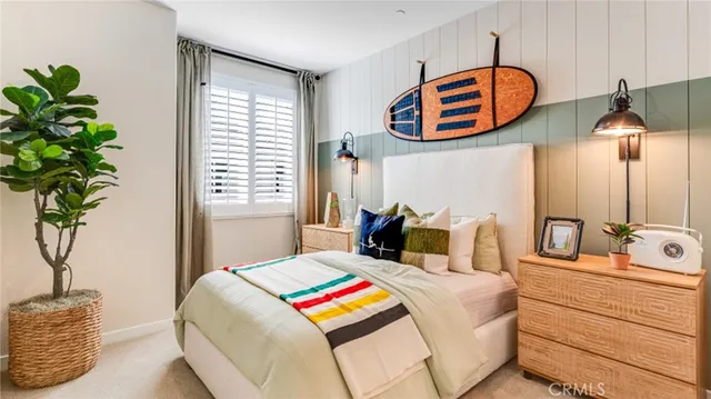 a bedroom with bed and a potted plant