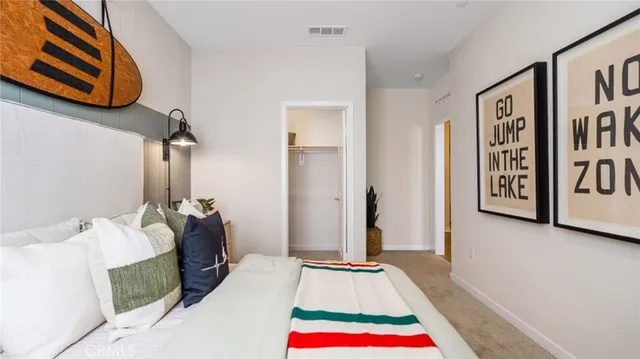 a bedroom with a bed and a rug