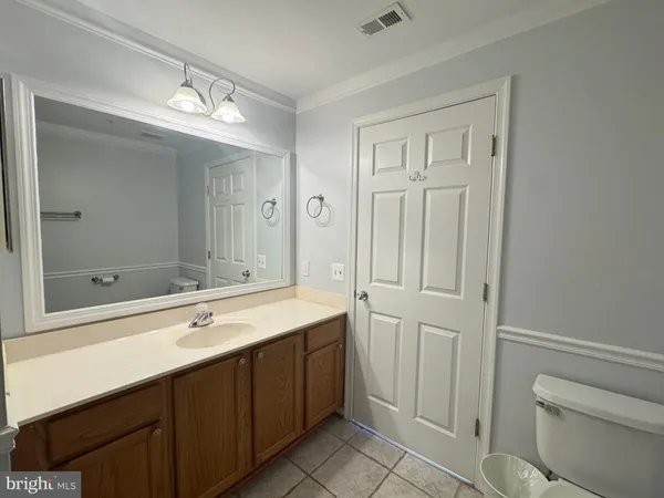 a bathroom with a double vanity sink and mirror with shower