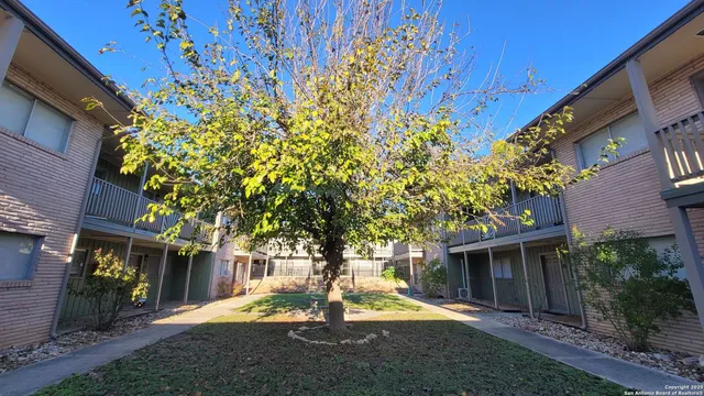 a front view of a building with a garden