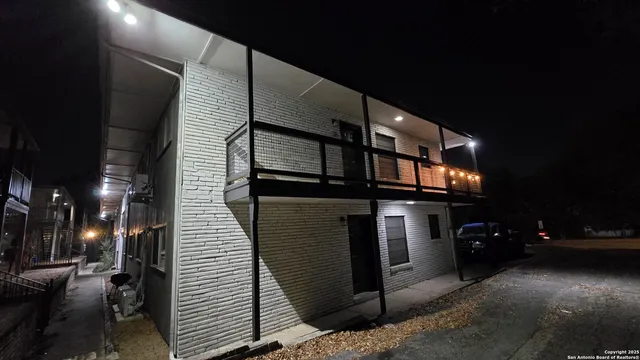 a view of a building with car parked