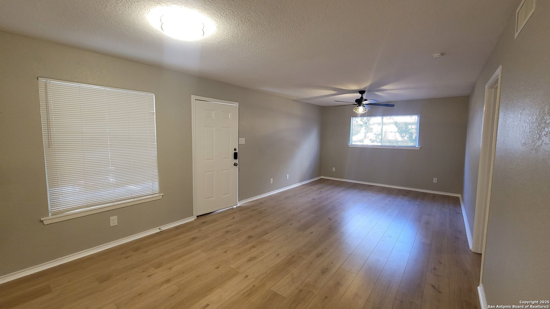 516 Gentleman Road, Unit 8 Balcones Heights, TX 78201 - Photo 4 of 33 an empty room with wooden floor and windows