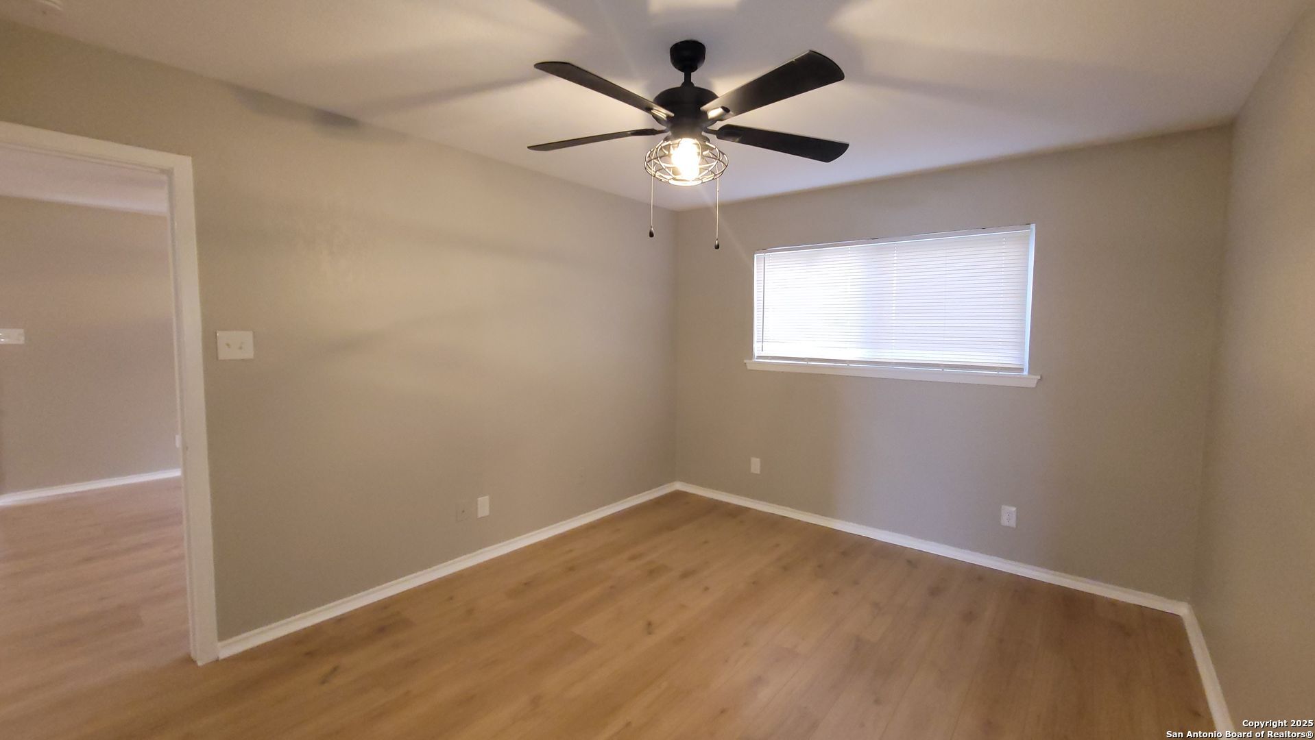 516 Gentleman Road, Unit 8 Balcones Heights, TX 78201 - Photo 8 of 33 an empty room with a window and a fan