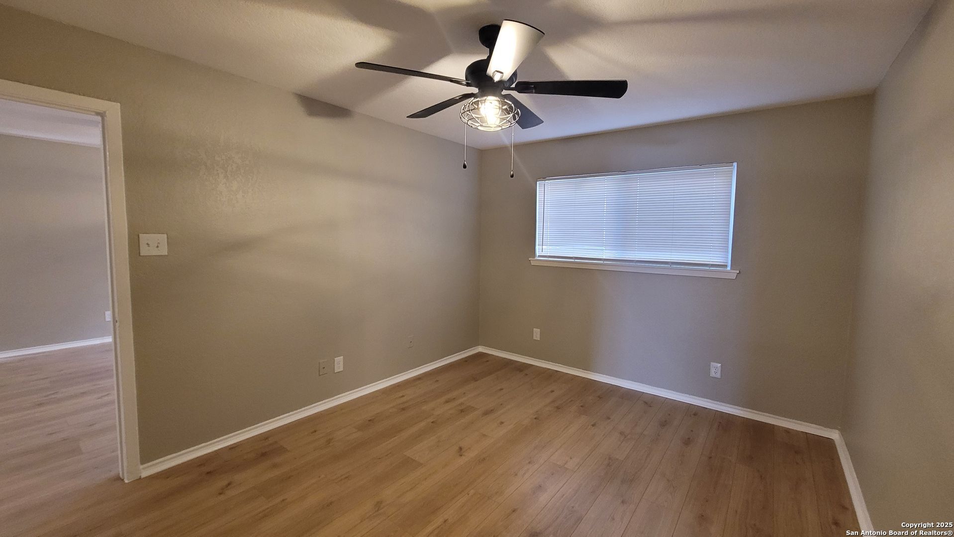 516 Gentleman Road, Unit 8 Balcones Heights, TX 78201 - Photo 10 of 33 a view of room with hardwood floor and a ceiling fan