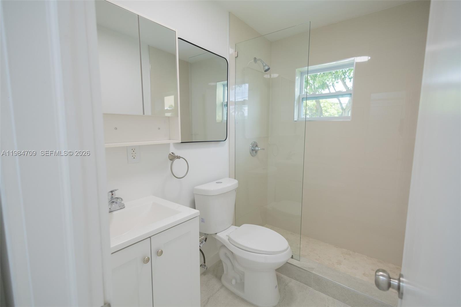 2675 Southwest 24th Terrace Miami, FL 33145 - Photo 18 of 36 a bathroom with a toilet a sink and shower
