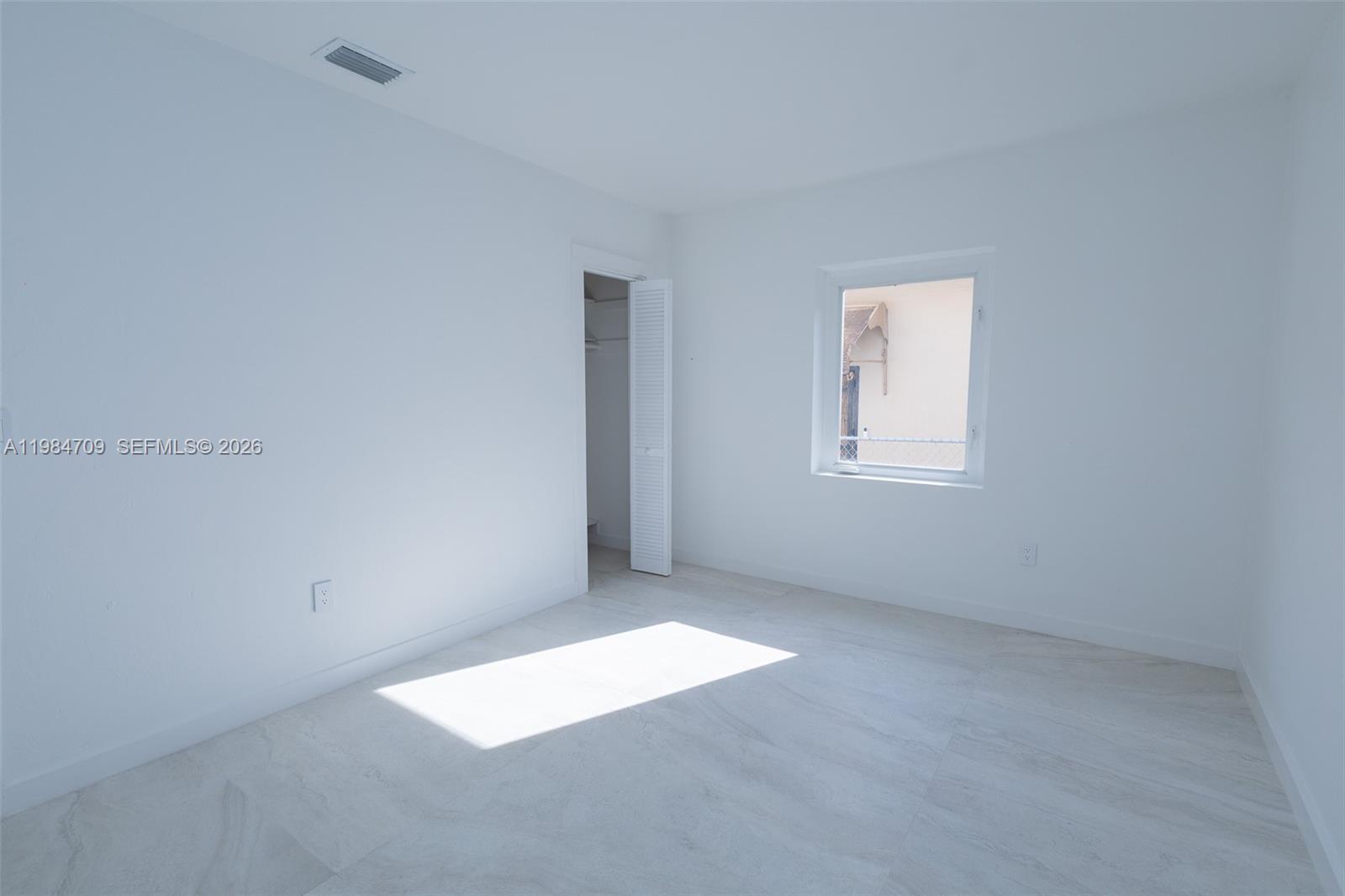2675 Southwest 24th Terrace Miami, FL 33145 - Photo 28 of 36 an empty room with windows