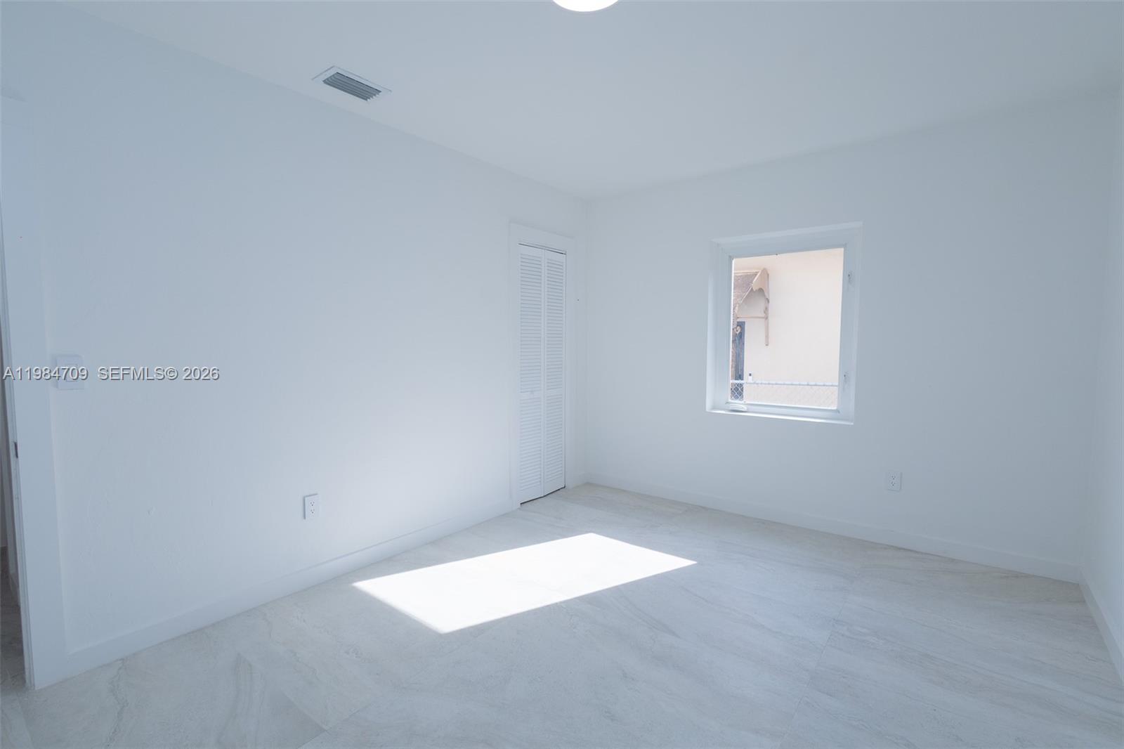 2675 Southwest 24th Terrace Miami, FL 33145 - Photo 30 of 36 an empty room with a window