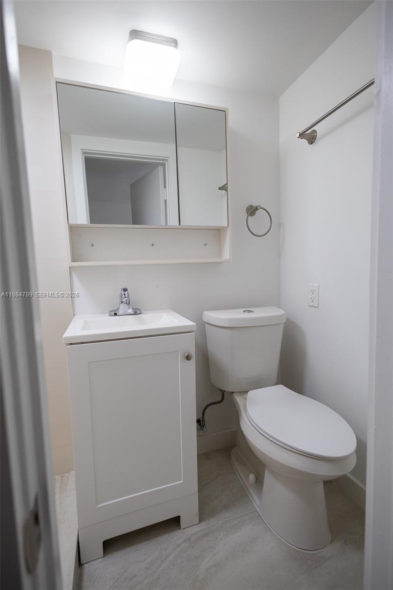 2675 Southwest 24th Terrace Miami, FL 33145 - Photo 33 of 36 a bathroom with a toilet sink and mirror